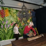 Members of the IFDA team install the mural and prep the table