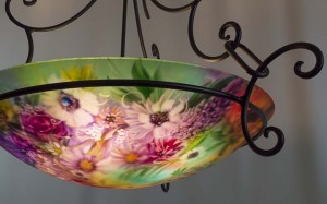 Sunflowers, roses, wildflowers and soft greens capture a spring morning in Jenny Floravita's new painted glass chandelier.